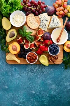 Assorted healthy cheese and fruits light snack Stock Photos