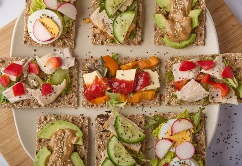 Assorted Healthy Crispbread Snacks with Fresh Toppings Stock Photos