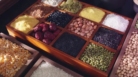 Assorted Healthy Grains and Nuts Displayed on Wooden Trays 動画素材 336559760