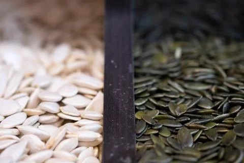 Assorted heap of raw pumpkin seeds texture. Food background bokeh Stock Photos