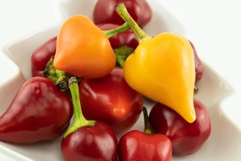 Assorted hot peppers in the shape of a flashlight red and yellow vegetable ba Stock Photos