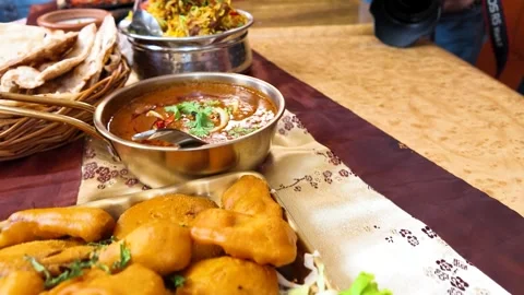 Assorted Indian Cuisine with Chicken Curry Biryani and Naan Bread Stock Footage 342714954