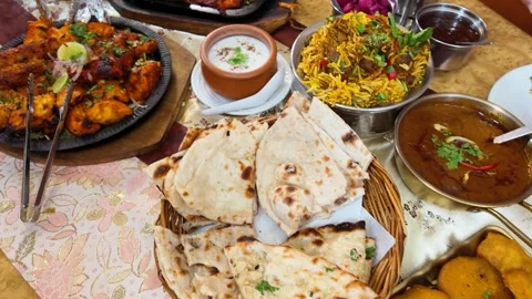 Assorted Indian Cuisine Feast with Chicken Tikka and Biryani Stock Footage 342698592