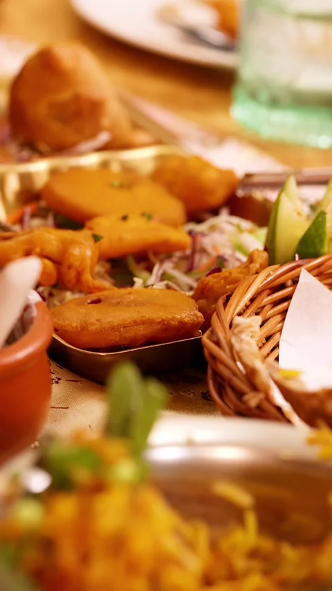 Assorted Indian Cuisine with Naan Bread and Samosas on Restaurant Table 스톡 동영상 339871065