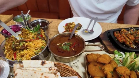Assorted Indian Cuisine Spread with Curry Biryani and Naan Bread Stock Footage 342713446