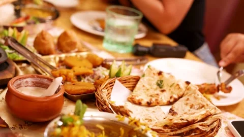 Assorted Indian Cuisine Spread with Naan Bread and Samosas Video stock 339119685