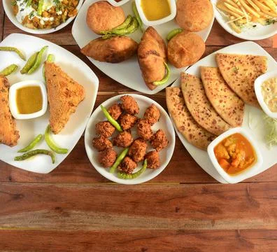 Assorted Indian Tea time snacks in group includes Spicy onion fritters, bread Stock Photos