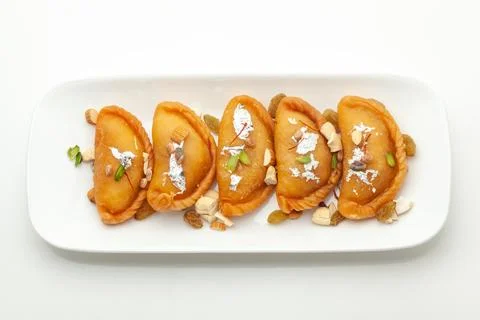 Assorted Indian traditional sweet"Gujiya" on a rectangular white plate. Stock Photos