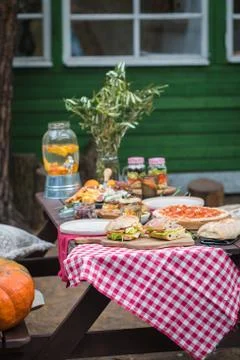 Assorted Italian food table setting in the garden, selective focus Stock Photos