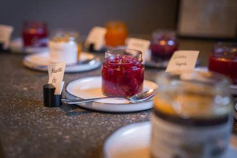 Assorted Jars of Jam on Plates in a Luxury Hotel Breakfast Setting Stock Photos