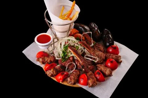 Assorted kebabs on a black background. Grilled meat on the bone, minced meat Stock-Fotos