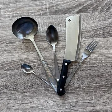 Assorted kitchen utensils on wooden table Stock Photos