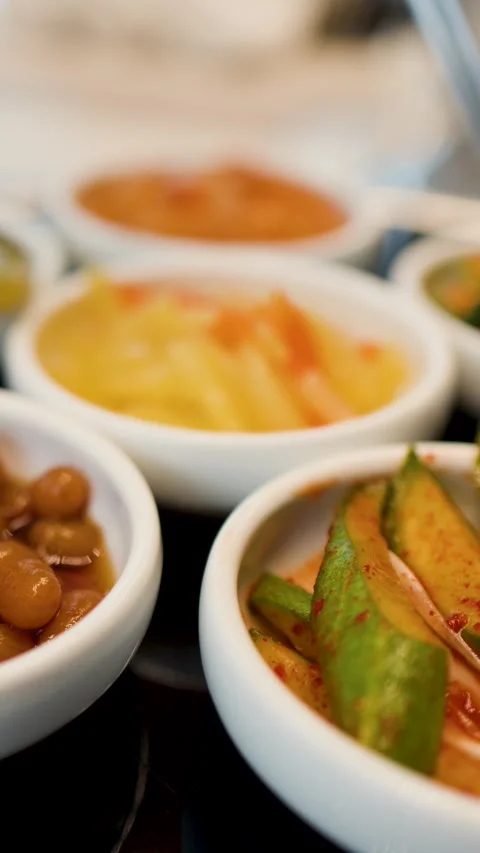 Assorted Korean Banchan Side Dishes in White Ceramic Bowls Stock Footage 335358429