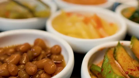 Assorted Korean Banchan Side Dishes in Small White Ceramic Bowls Stock Footage 335359683