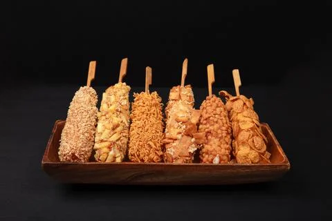 Assorted Korean Corn Dogs with Unique Toppings on Wooden Platter Stock Photos