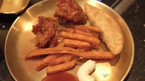 Assorted Korean Fried Chicken and Sides on Brass Plate Stock Footage 340253762