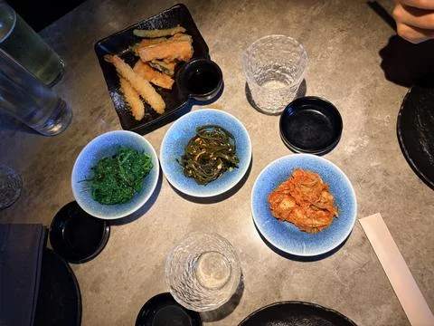 Assorted Korean Side Dishes and Tempura on Restaurant Table Stock-Fotos
