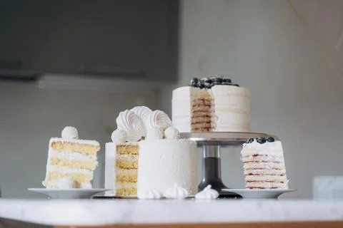 Assorted Layered Cakes Displayed on Marble Counter Stock Photos