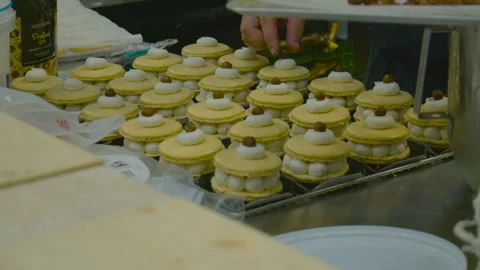 Assorted layered macarons with cream and hazelnuts in a pastry kitchen. Stock Footage 318631603