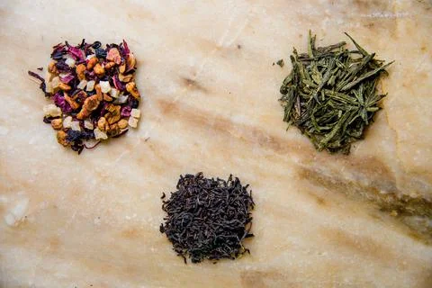Assorted leafy green, fruit and black tea. Stock Photos