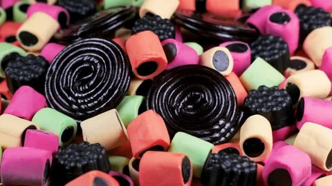 Assorted Licorice Candies Rotating Macro Background Stockbeeldmateriaal 336810092