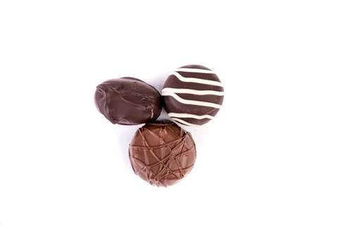 Assorted light and dark chocolates isolated over white background top down vi Stock Photos