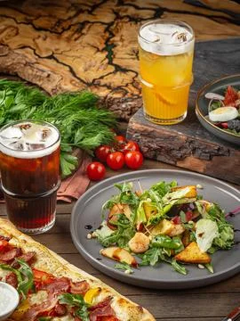 Assorted lunch table with salad and pizza Stock Photos