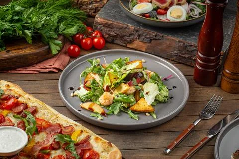 Assorted lunch table with salad and pizza Stock Photos