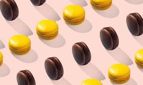 Assorted macarons pattern lemon and chocolate. Pink background isolated Stock Photos