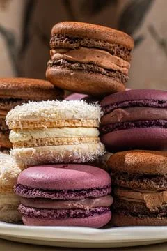 Assorted macarons stacked on decorative plate 스톡 사진