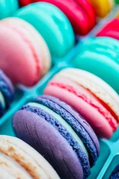 Assorted macaroons sweets, close up, backdrop. Marine, pink and violet. Stock Photos