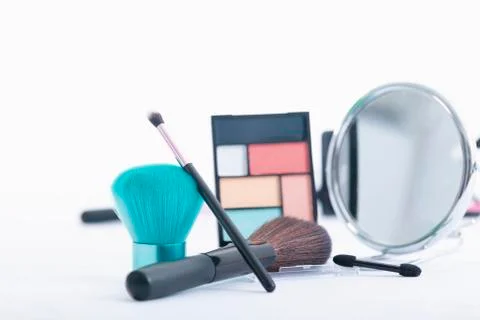 Assorted makeup brushes with mirror and accessories Stock Photos