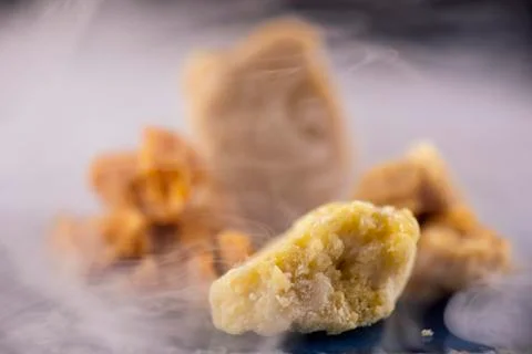 Assorted marijuana extraction concentrate aka wax crumble on smoky background Stock Photos