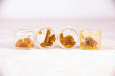 Assorted marijuana extraction concentrate aka wax crumble on jars isolated on Stock Photos