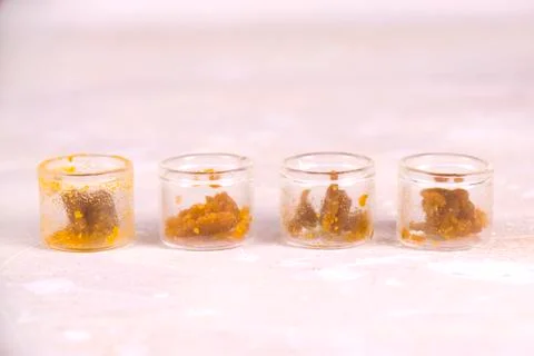Assorted marijuana extraction concentrate aka wax crumble on jars isolated on Stock Photos