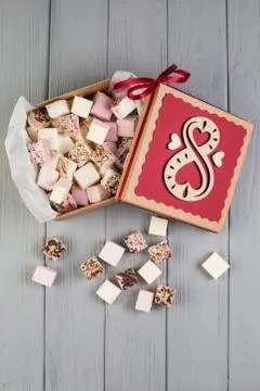 Assorted marshmallow on grey wood table with gift box for eight march Stock Photos