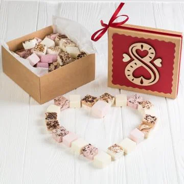 Assorted marshmallow on white wood table with gift box for eight march Stock Photos