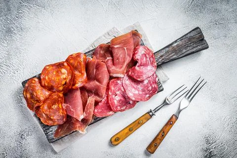 Assorted meat appetizers - salami, jamon, choriso sausages. White background Stock Photos