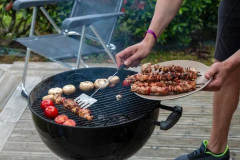 Assorted meat from chicken and various vegetables on barbecue grill Stock Photos