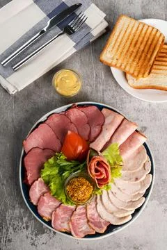 Assorted meat delicacies in a plate on the table Stock Photos