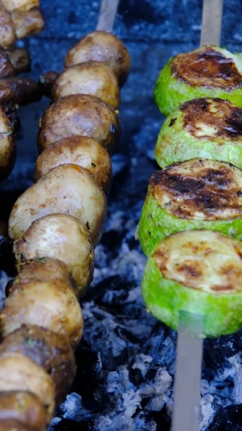 Assorted Meat Potatoes Mushrooms Zucchini and Vegetables Grilling on Metal Stock Footage 346252079