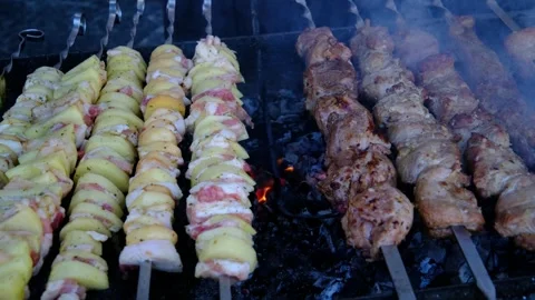 Assorted Meat Potatoes Mushrooms Zucchini and Vegetables Grilling on Metal Stock Footage 346263631