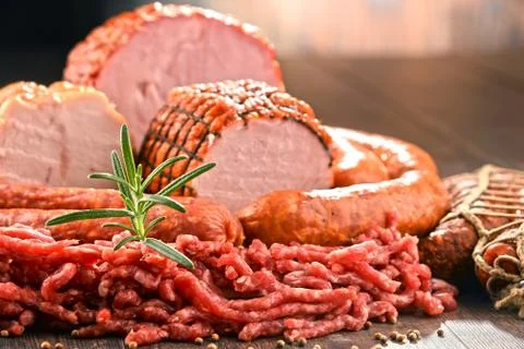 Assorted meat products including ham and sausages. Stock Photos