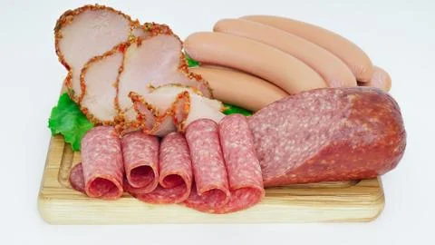 Assorted meat products including ham and sausages. Stock Photos