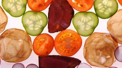 Assorted meat with vegetables rotating on white background in 4K Vídeos de archivo 85923265