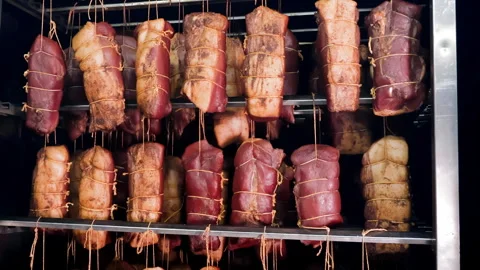 Assorted Meats Curing in a Smokehouse, Diverse cuts of meat being cured, tied up Stock Footage 272161636