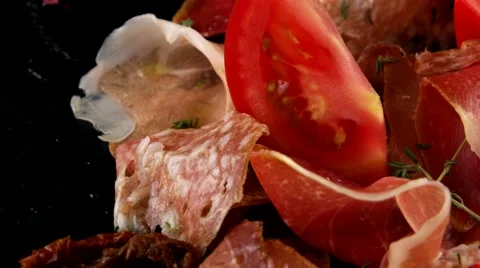 Assorted meats (ham, salami, bacon) and tomatoes, closeup Stock Footage 66481989