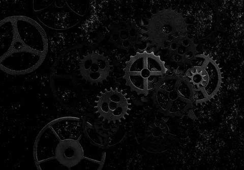 Assorted mechanical grunge gears on gritty black background Stock Photos