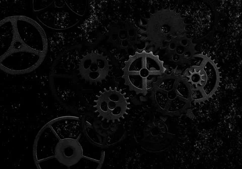 Assorted mechanical grunge gears on gritty black background Stock Photos