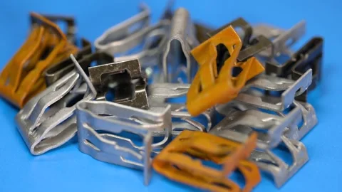 Assorted metal clips close up view, used for mounting automotive trim and o.. Video stock 326860963